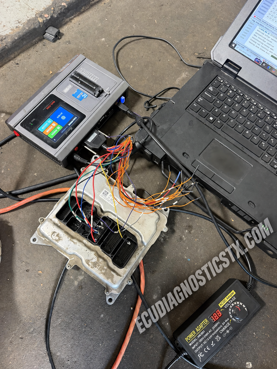 BMW N55 ECU connected to bench programming equipment during an on-site service