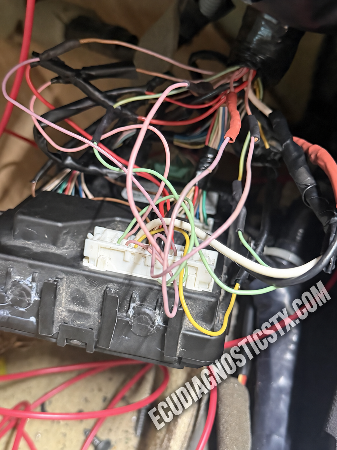 Infiniti Q50 BCM wiring harness during mobile fire-damage diagnosis and repair in Houston